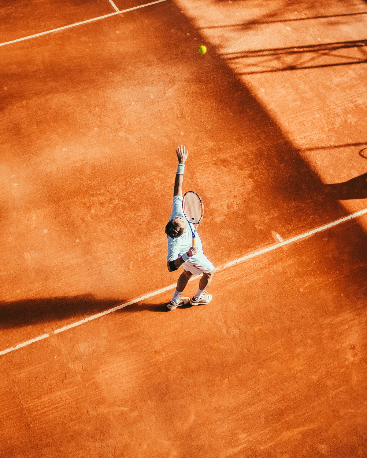Tennis player training on an outdoor court